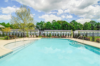 a swimming pool with a fence and trees in the background  at Ashbrook Village, Gastonia, 28054
